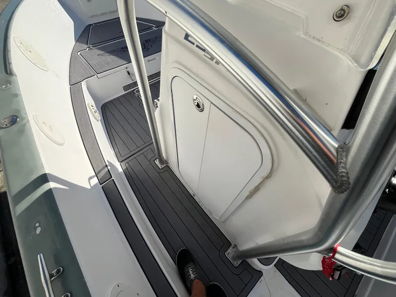 Slide: The Image of 2003 Pro-Line 25 Sport CC boat interior with stainless steel railings and non-slip flooring. - 16