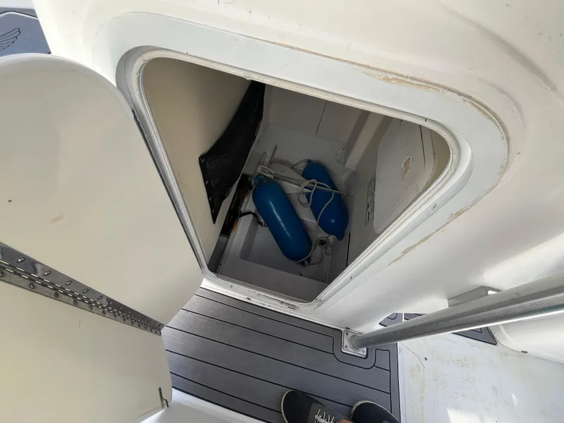 Slide: The Image of Storage compartment on a 2003 Pro-Line 25 Sport CC boat with blue fenders. - 17