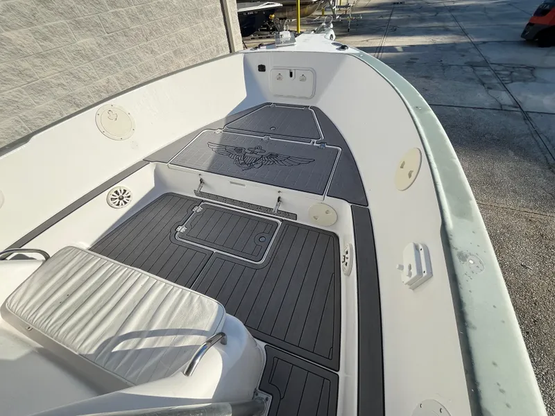 Slide: The Image of 2003 Pro-Line 25 Sport CC boat deck with custom flooring and seating. - 19