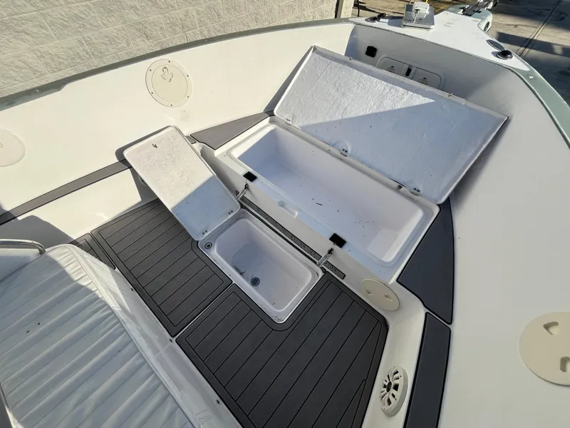 Slide: The Image of 2003 Pro-Line 25 Sport CC boat interior with open storage compartments. - 22