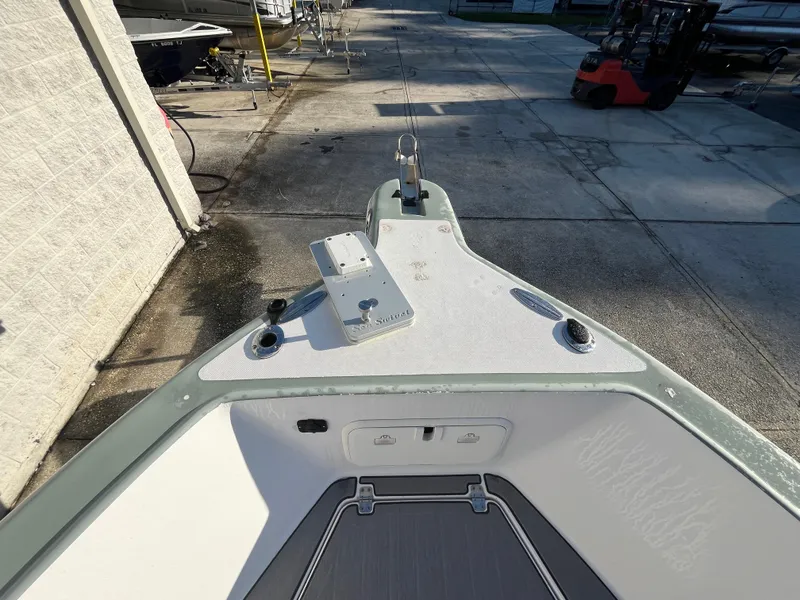 Slide: The Image of 2003 Pro-Line 25 Sport CC boat bow view in a marina setting. - 25