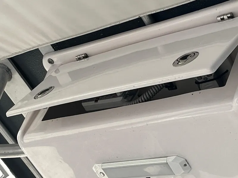 Slide: The Image of Open storage compartment on a 2003 Pro-Line 25 Sport CC boat. - 28