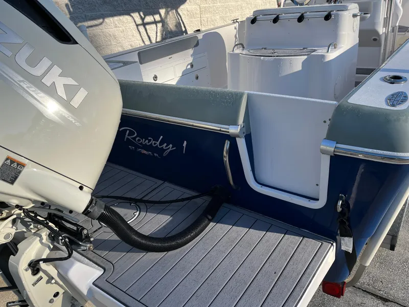 Slide: The Image of 2003 Pro-Line 25 Sport CC boat with Suzuki outboard motor, rear deck view. - 29