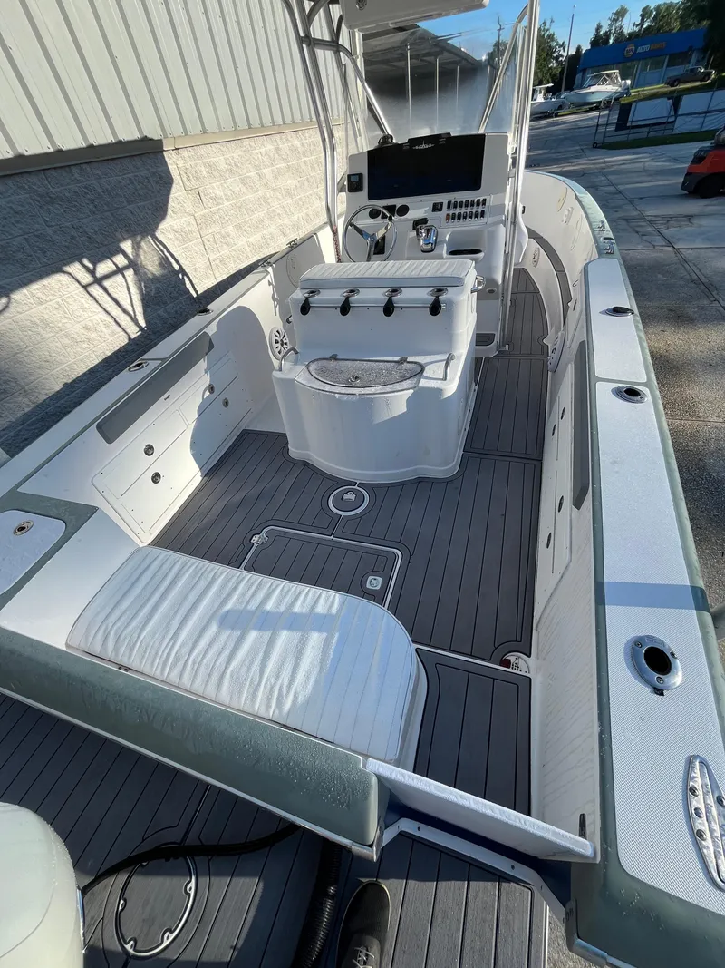 Slide: The Image of 2003 Pro-Line 25 Sport CC boat interior with seating and control console. - 30
