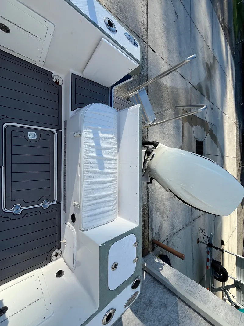 Slide: The Image of 2003 Pro-Line 25 Sport CC boat deck with seating and outboard motor. - 31