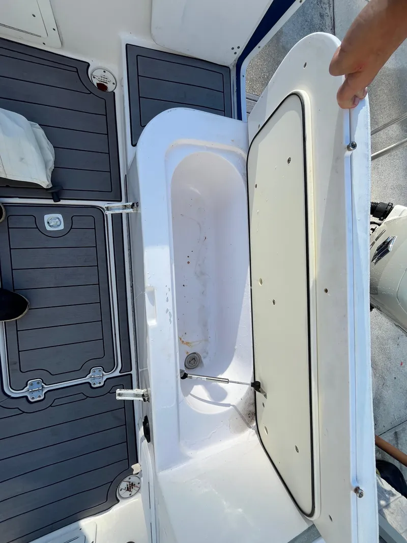 Slide: The Image of Open storage compartment on 2003 Pro-Line 25 Sport CC boat deck. - 6