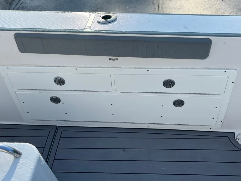 Slide: The Image of 2003 Pro-Line 25 Sport CC boat storage compartments and deck view. - 8