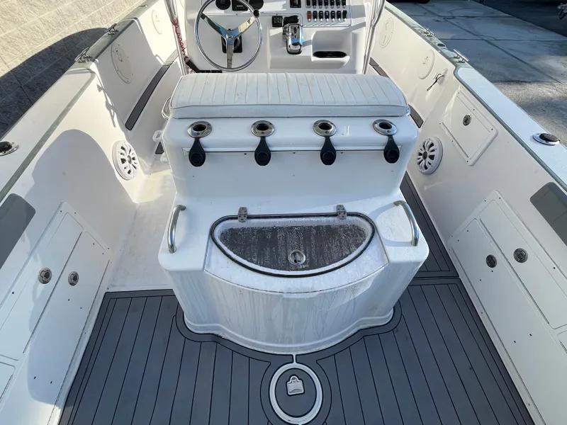Slide: The Image of 2003 Pro-Line 25 Sport CC boat interior with fishing rod holders and steering console. - 9