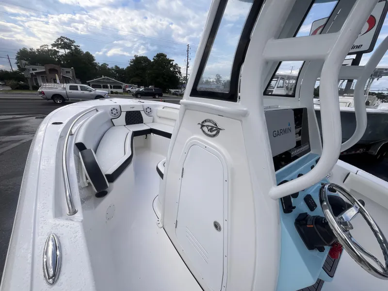 Slide: The Image of 2023 Tidewater 232 CC Adventure boat interior with seating and Garmin navigation system. - 10