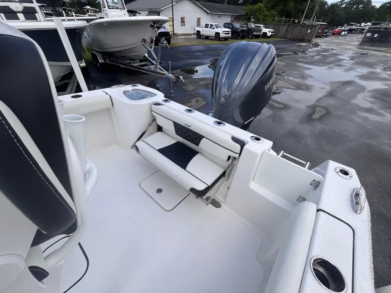 Slide: The Image of 2023 Tidewater 232 CC Adventure boat with Yamaha outboard engine, docked in a marina. - 13