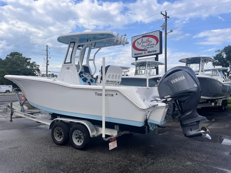 Slide: The Image of 2023 Tidewater 232 CC Adventure boat with Yamaha engine on trailer at dealership. - 2