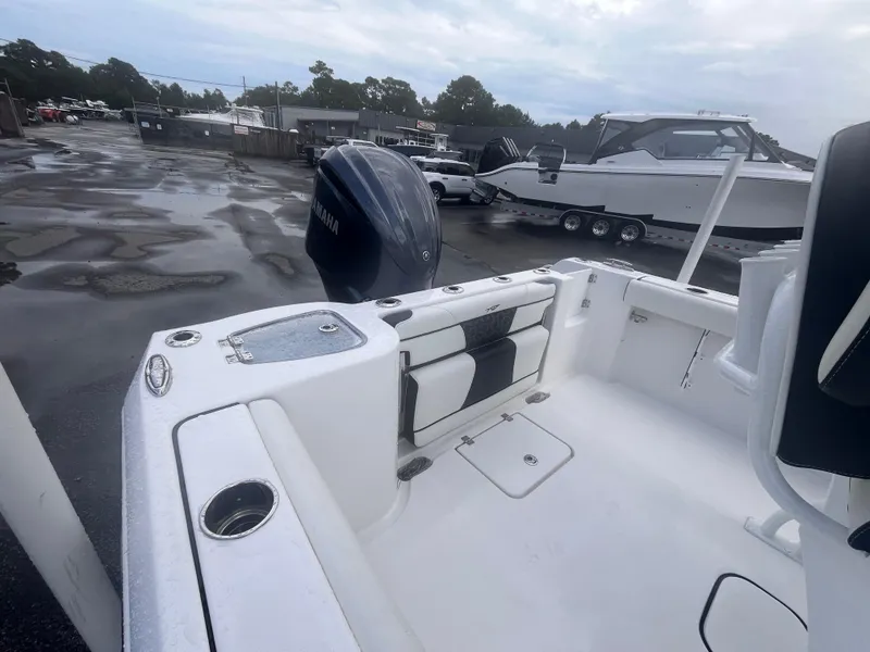 Slide: The Image of 2023 Tidewater 232 CC Adventure boat with Yamaha engine in a wet parking lot. - 5