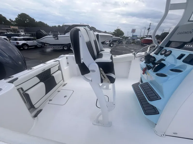 Slide: The Image of 2023 Tidewater 232 CC Adventure boat interior with seating and control panel. - 6