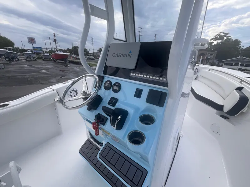 Slide: The Image of 2023 Tidewater 232 CC Adventure boat console with Garmin navigation system and steering wheel. - 7