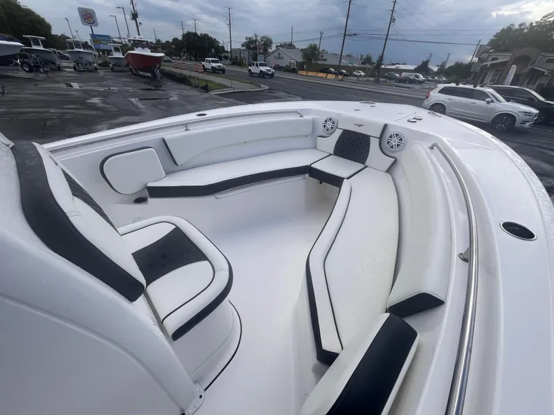 Slide: The Image of 2023 Tidewater 232 CC Adventure boat interior with cushioned seating and speakers. - 9