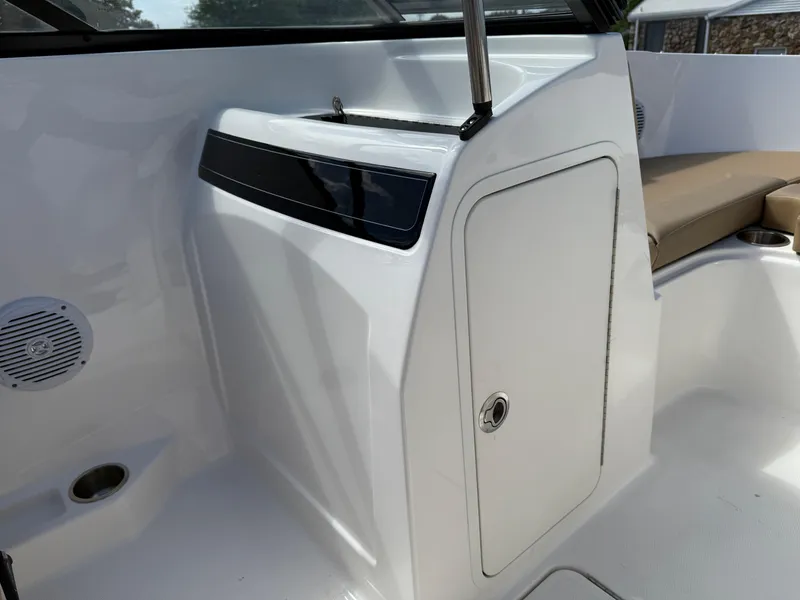 Slide: The Image of 2025 Bayliner VR4 Bowrider I/O interior with storage compartment and seating area. - 10