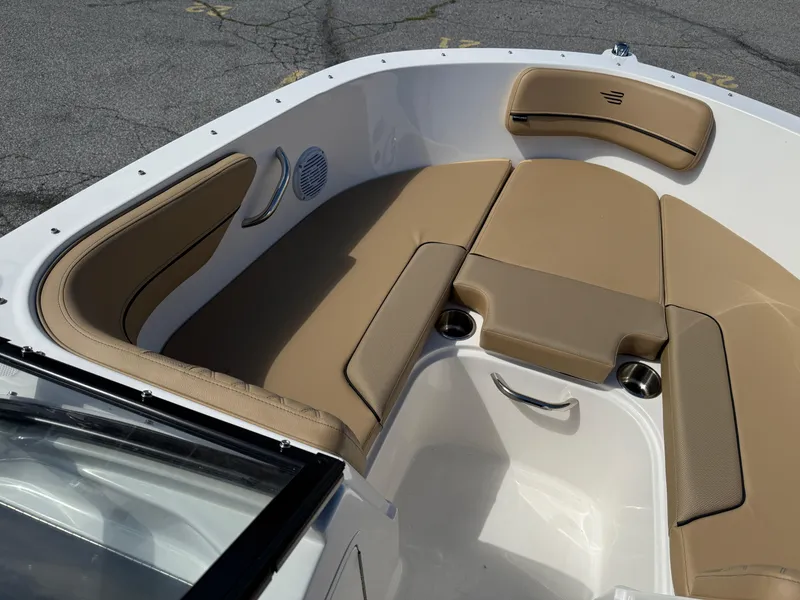Slide: The Image of 2025 Bayliner VR4 Bowrider I/O interior with tan seating and stainless steel accents. - 11