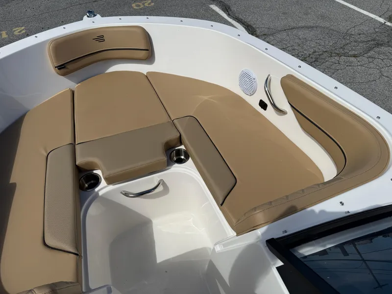 Slide: The Image of 2025 Bayliner VR4 Bowrider I/O boat interior with tan seating and cup holders. - 12