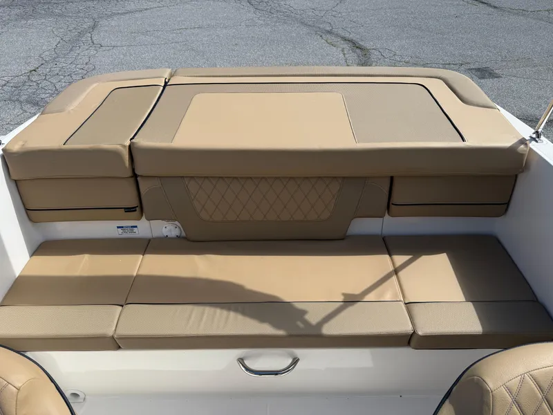 Slide: The Image of 2025 Bayliner VR4 Bowrider I/O interior seating with tan upholstery and diamond stitching. - 4