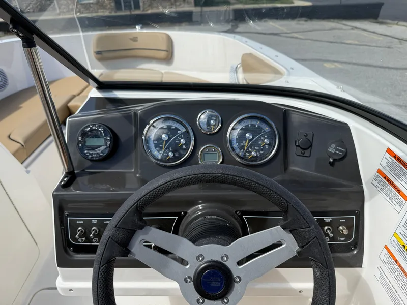 Slide: The Image of 2025 Bayliner VR4 Bowrider I/O dashboard with steering wheel and instrument panel. - 8