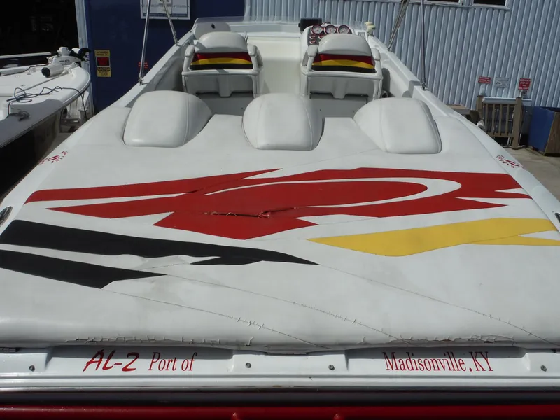 Slide: The Image of 2003 Baja 36 Outlaw boat with colorful graphics, docked in Madisonville, KY. - 11