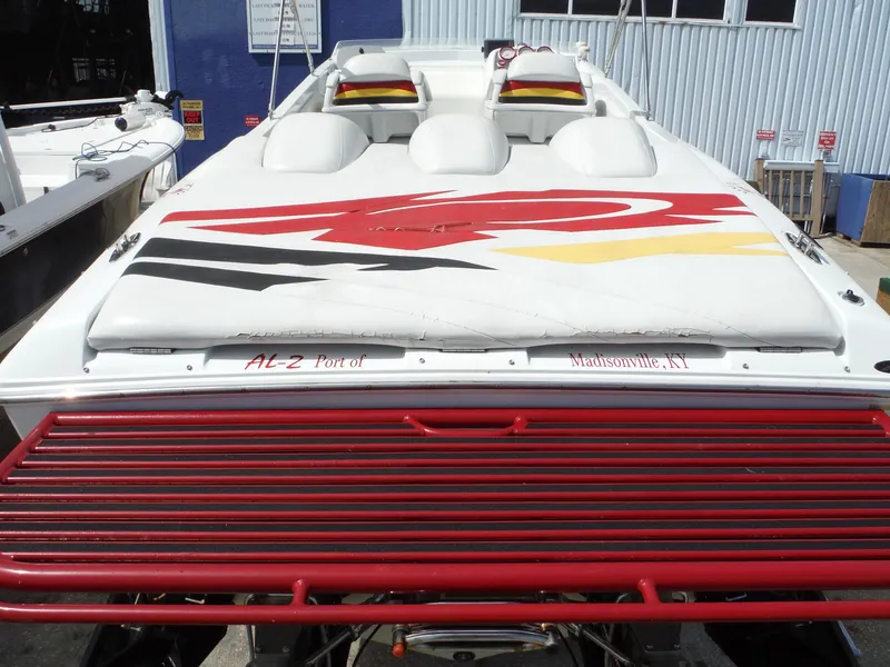 Slide: The Image of 2003 Baja 36 Outlaw speedboat with vibrant graphics, docked in Madisonville, KY. - 12