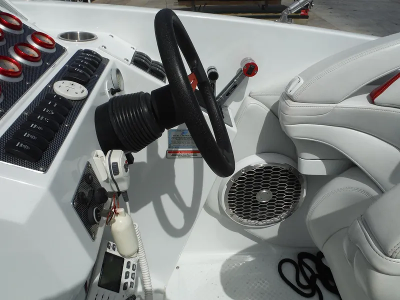 Slide: The Image of 2003 Baja 36 Outlaw boat cockpit with steering wheel and control panel. - 16