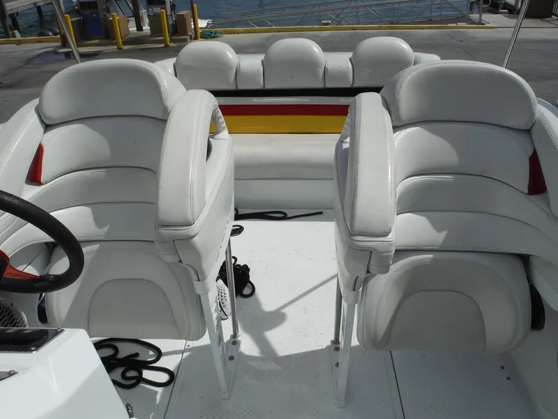 Slide: The Image of 2003 Baja 36 Outlaw boat interior with white seating and steering wheel. - 18