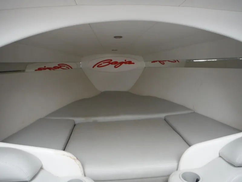 Slide: The Image of Interior cabin of 2003 Baja 36 Outlaw boat with cushioned seating. - 21