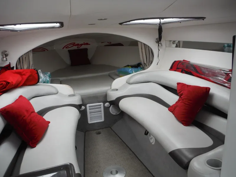 Slide: The Image of 2003 Baja 36 Outlaw cabin interior with white seating and red accents. - 24