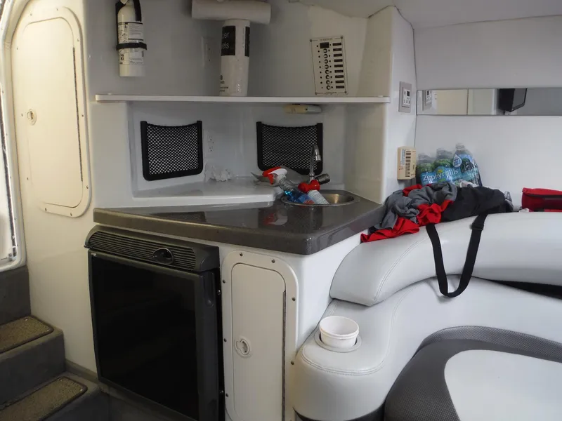 Slide: The Image of 2003 Baja 36 Outlaw cabin interior with kitchenette, seating, and storage. - 32