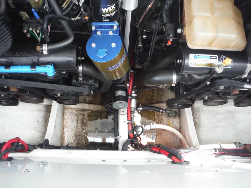 Slide: The Image of Engine compartment of a 2003 Baja 36 Outlaw boat, showcasing mechanical components. - 40