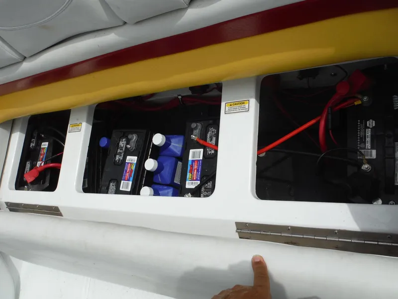 Slide: The Image of 2003 Baja 36 Outlaw boat battery compartment with visible wiring and caution labels. - 41