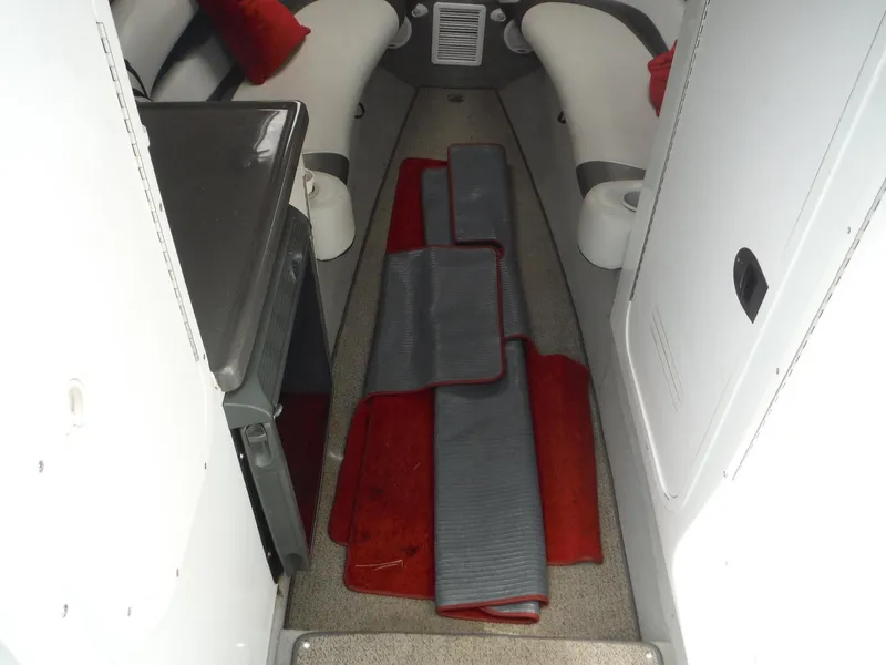 Slide: The Image of 2003 Baja 36 Outlaw cabin interior with seating and red accents. - 42