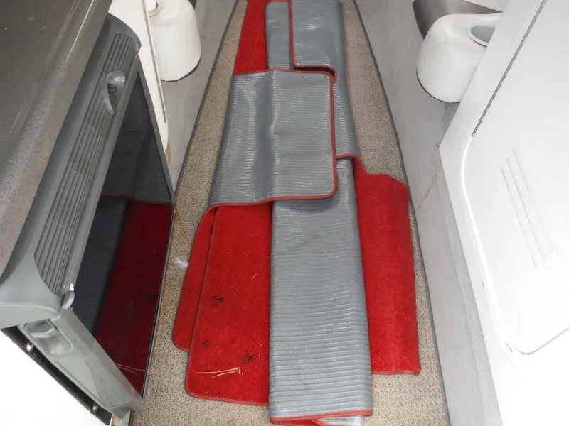 Slide: The Image of Interior of a 2003 Baja 36 Outlaw boat with red and gray floor mats. - 43