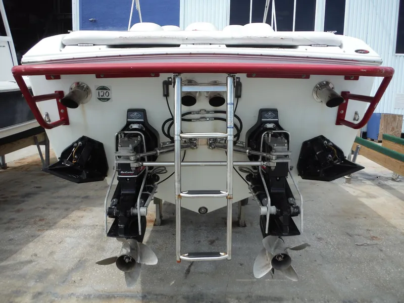 Slide: The Image of 2003 Baja 36 Outlaw boat rear view with dual propellers and ladder. - 49