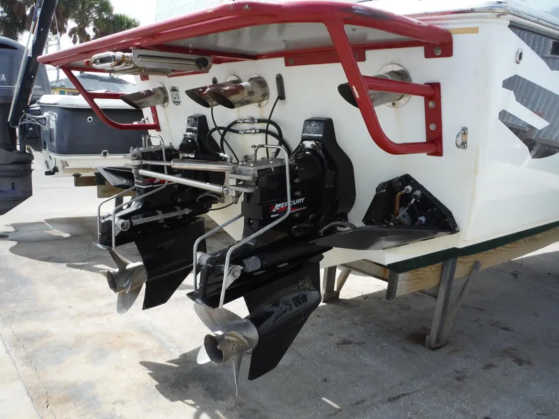 Slide: The Image of 2003 Baja 36 Outlaw boat with dual Mercury outboard engines and red accents. - 9