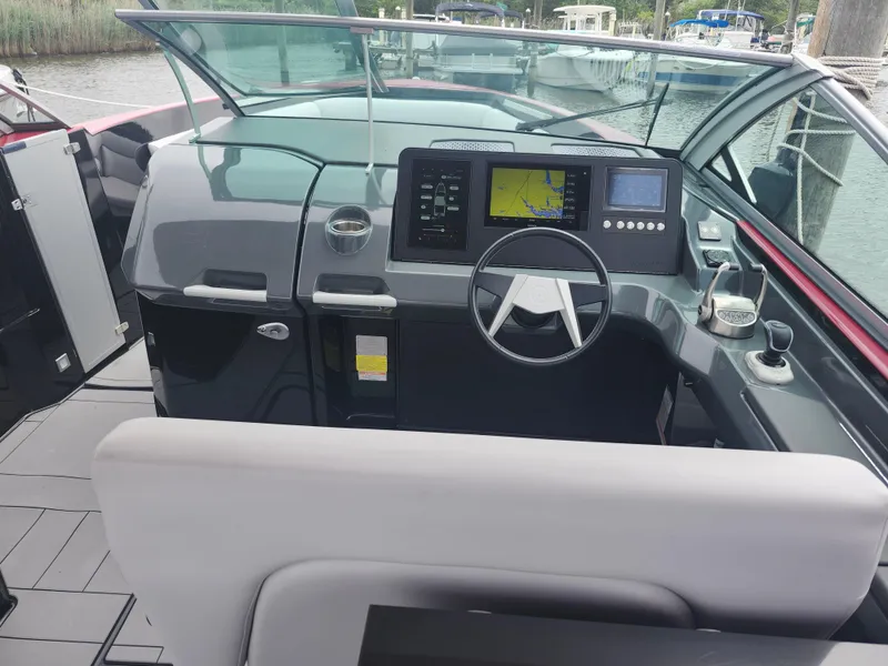 Slide: The Image of Cockpit of 2020 Aviara AV32 I/O boat with modern navigation system and steering wheel. - 11