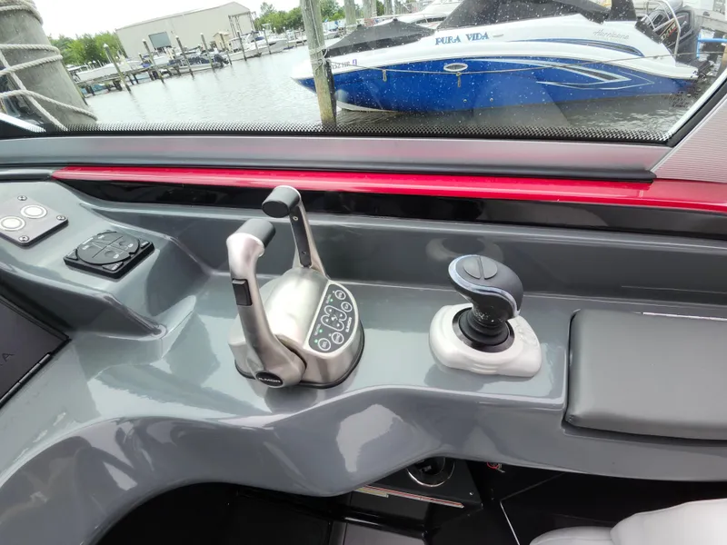 Slide: The Image of Control panel of a 2020 Aviara AV32 I/O boat, featuring throttle and joystick controls. - 13