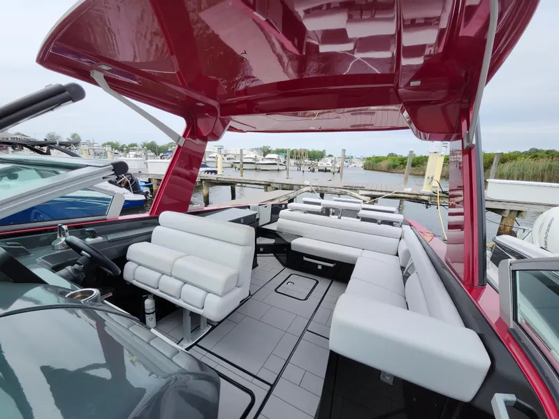 Slide: The Image of 2020 Aviara AV32 I/O boat with sleek red canopy and luxurious white seating. - 15