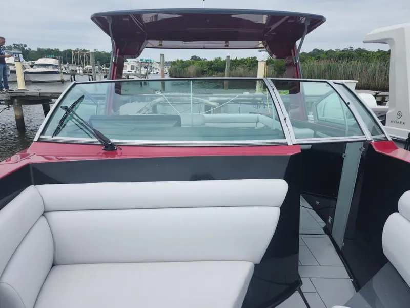 Slide: The Image of 2020 Aviara AV32 I/O boat interior with sleek seating and modern design at a marina. - 18