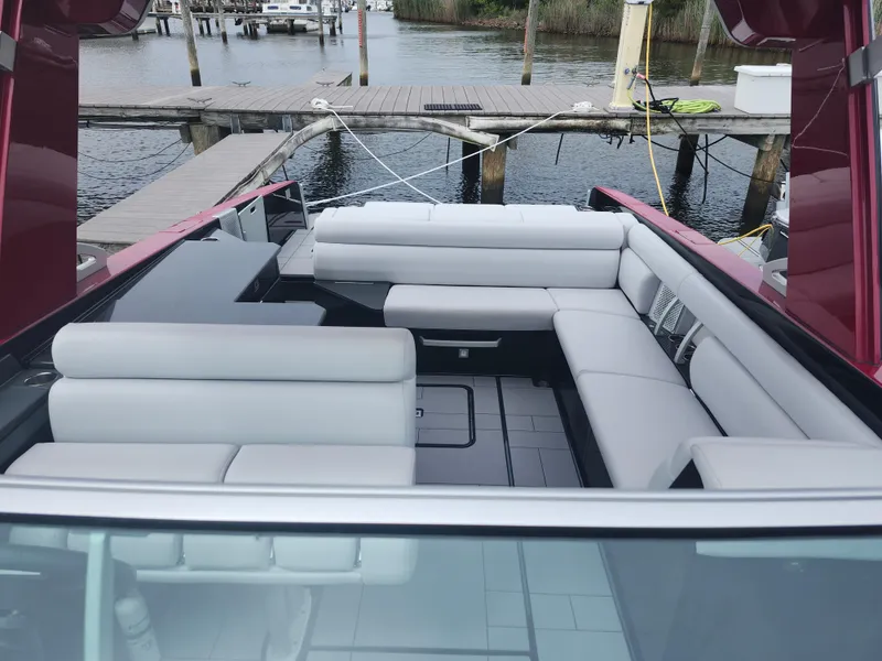 Slide: The Image of 2020 Aviara AV32 I/O boat interior with white seating, docked at a marina. - 19