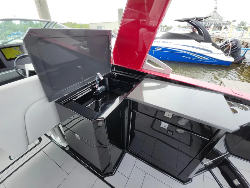 Slide: The Image of 2020 Aviara AV32 I/O boat interior with sleek black kitchenette and modern design. - 20