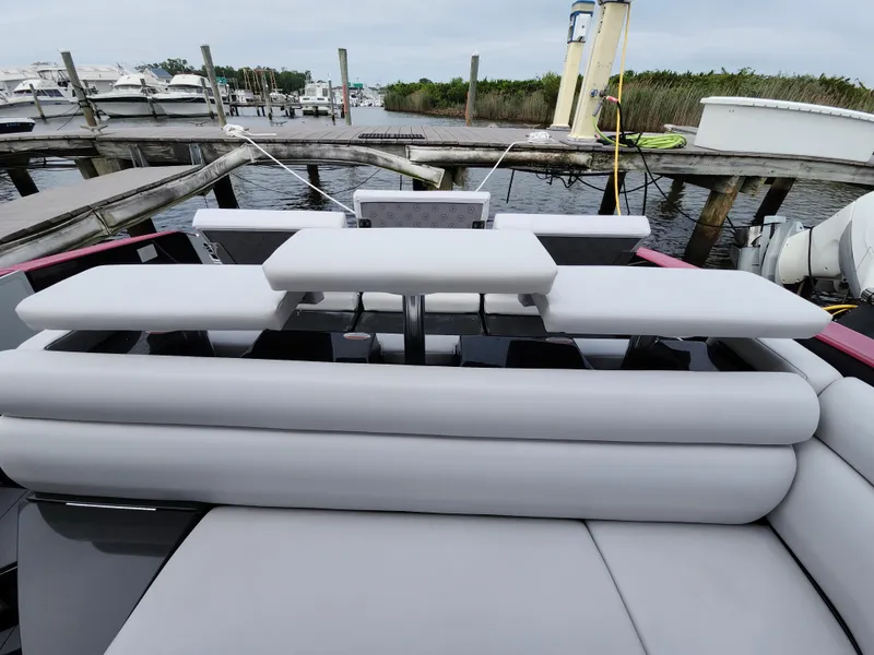 Slide: The Image of 2020 Aviara AV32 I/O boat with sleek seating at a marina dock. - 23