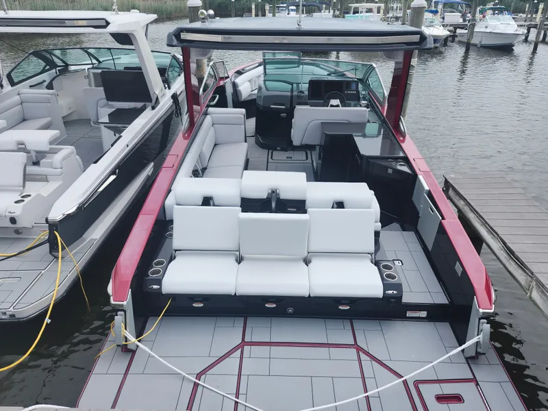 Slide: The Image of 2020 Aviara AV32 I/O boat with sleek design and spacious seating at a marina. - 4