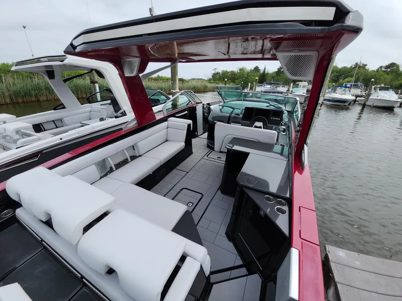 Slide: The Image of 2020 Aviara AV32 I/O luxury boat with spacious seating and sleek design at a marina. - 5