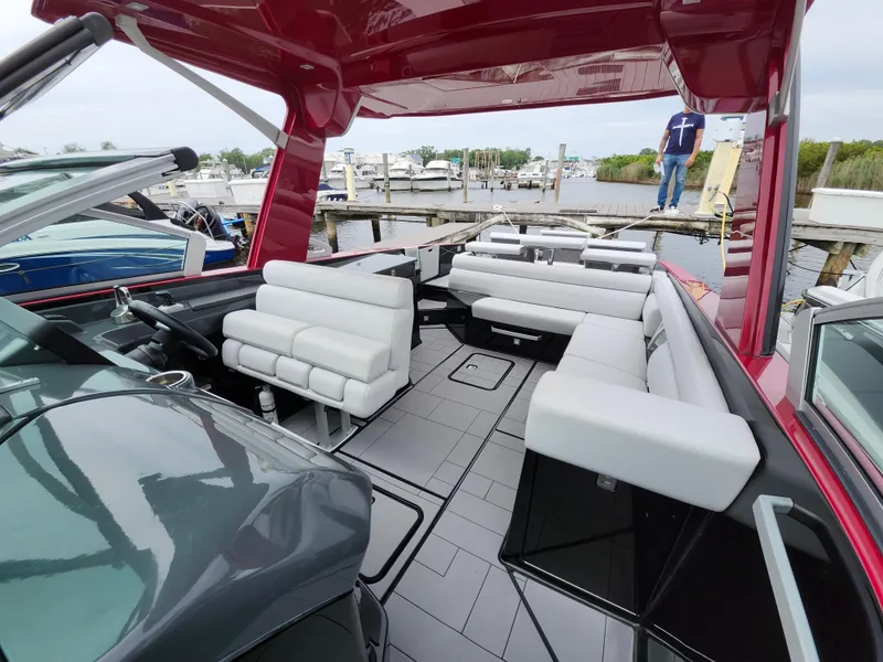 Slide: The Image of 2020 Aviara AV32 I/O boat with spacious seating and modern design at a marina. - 7