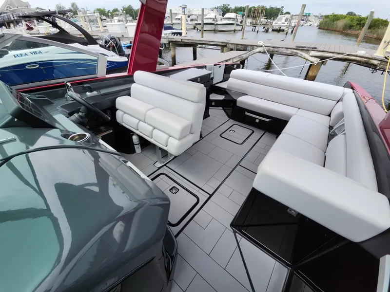 Slide: The Image of 2020 Aviara AV32 I/O boat interior with sleek seating and modern design at a marina. - 8
