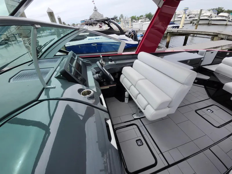 Slide: The Image of 2020 Aviara AV32 I/O boat interior with white seating and modern dashboard at marina. - 9