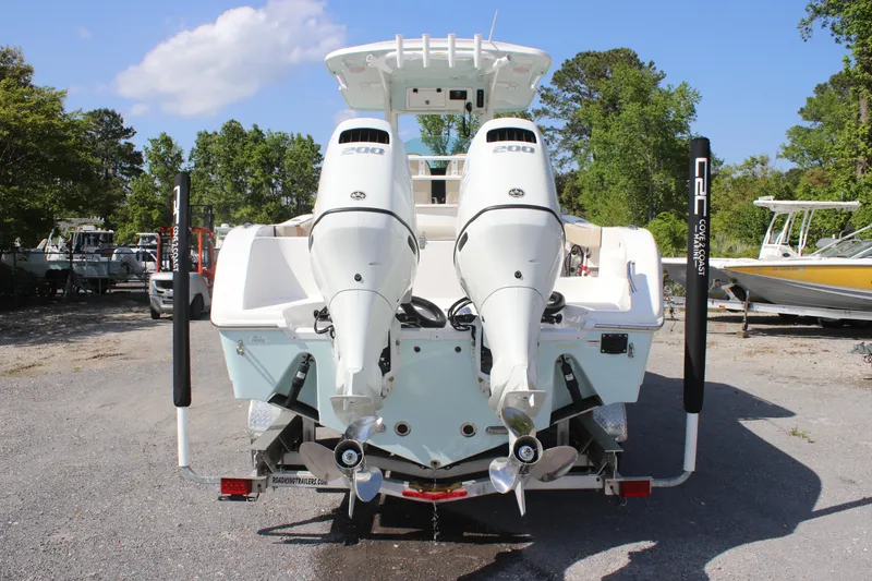 Slide: The Image of 2023 Sea Pro 259 Deep V CC boat with dual outboard engines, parked on a trailer. - 3
